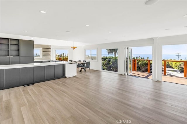 kitchen featuring light wood-type flooring and decorative light fixtures