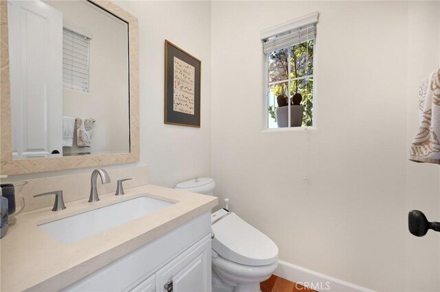 bathroom featuring vanity and toilet