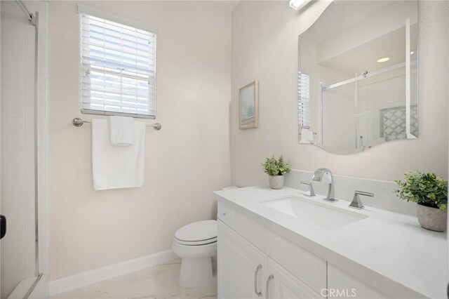 bathroom featuring toilet, walk in shower, and vanity