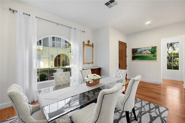 dining space with light hardwood / wood-style flooring