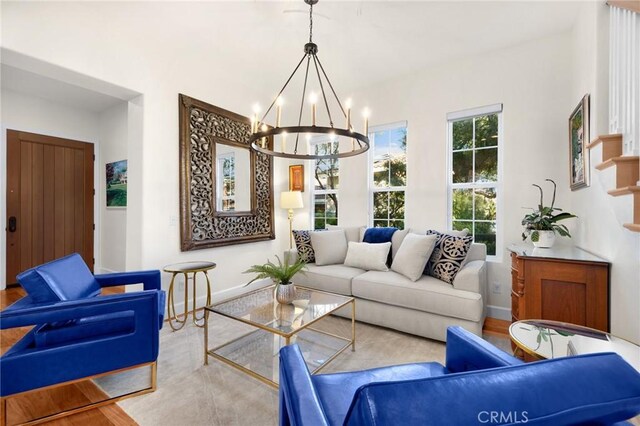 living room with hardwood / wood-style flooring and a notable chandelier