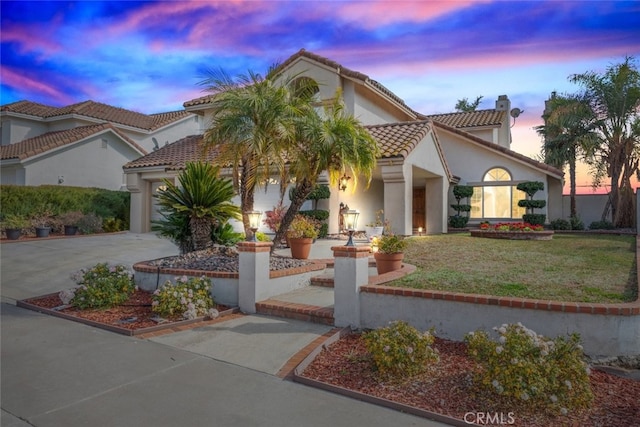 mediterranean / spanish house with a lawn