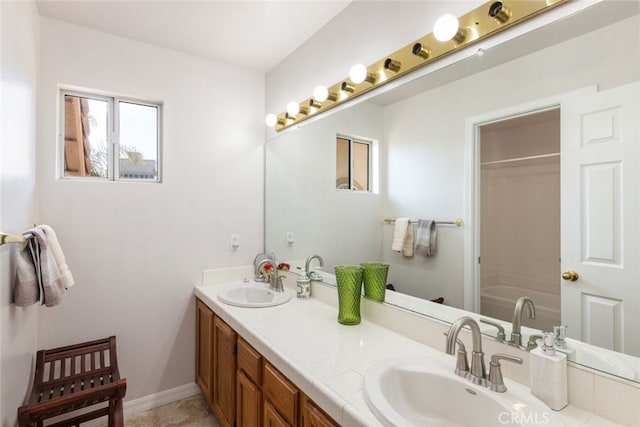 bathroom with vanity and a bath