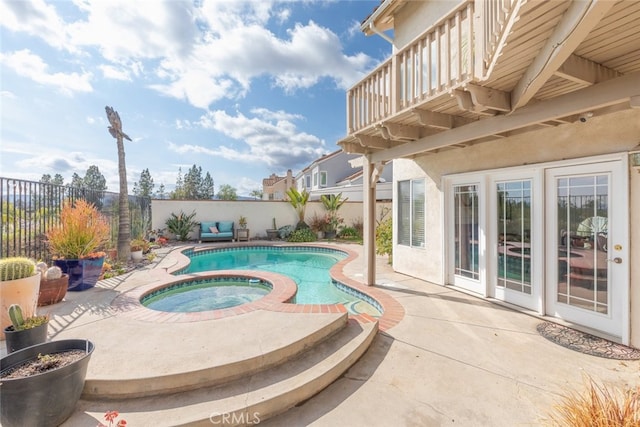 view of swimming pool featuring an in ground hot tub and a patio area