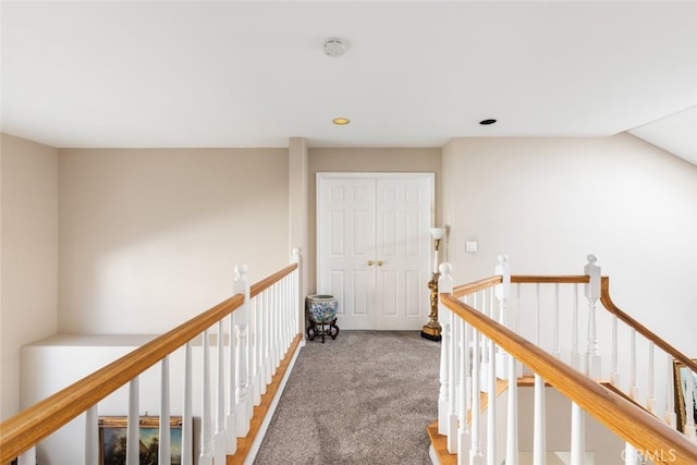 hall featuring vaulted ceiling and carpet