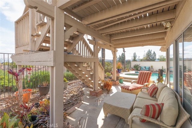 view of patio / terrace with a swimming pool with hot tub