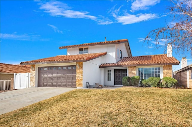 mediterranean / spanish-style house with a garage and a front lawn