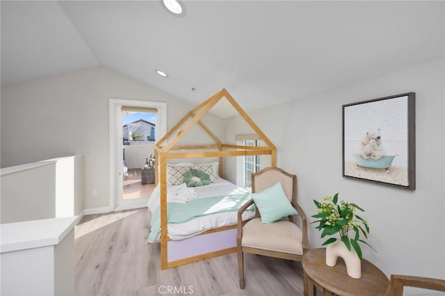 bedroom featuring vaulted ceiling and light hardwood / wood-style flooring