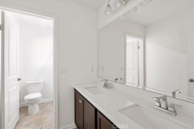 bathroom with toilet and vanity