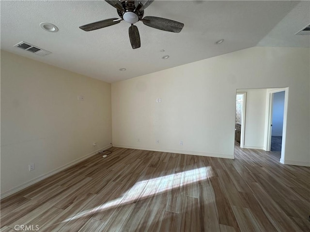 unfurnished room with lofted ceiling, ceiling fan, and hardwood / wood-style flooring