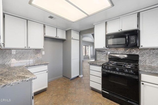 kitchen featuring black appliances, decorative backsplash, light stone countertops, and white cabinetry