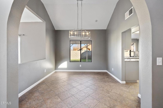 unfurnished dining area with vaulted ceiling