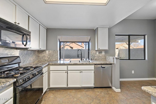 kitchen featuring light stone countertops, white cabinets, black appliances, decorative backsplash, and sink