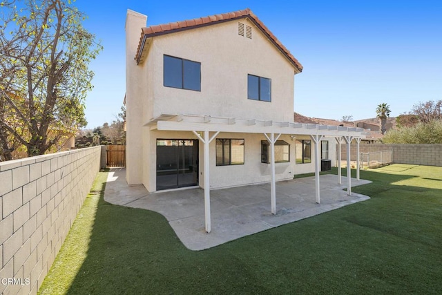 back of property with a pergola, a lawn, and a patio