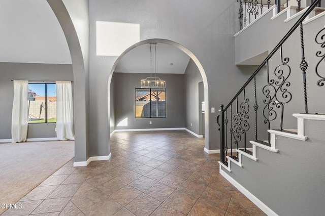 entrance foyer with a high ceiling and a chandelier