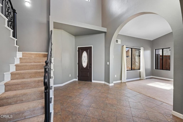 foyer entrance with carpet floors