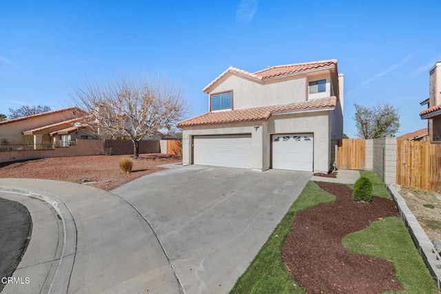 mediterranean / spanish home featuring a garage