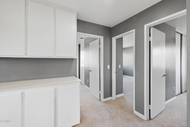 hallway with light colored carpet