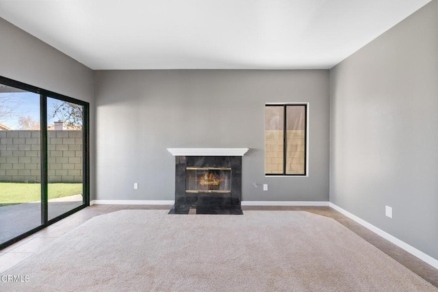 unfurnished living room with light colored carpet and a fireplace