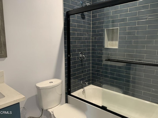 full bathroom with toilet, vanity, and shower / bath combination with glass door