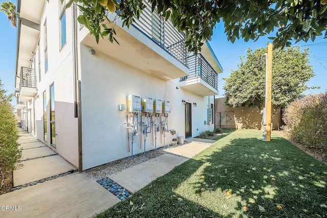 view of property exterior with a lawn