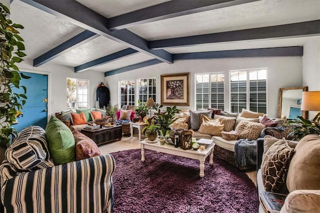 tiled living room featuring vaulted ceiling with beams, a healthy amount of sunlight, and a textured ceiling