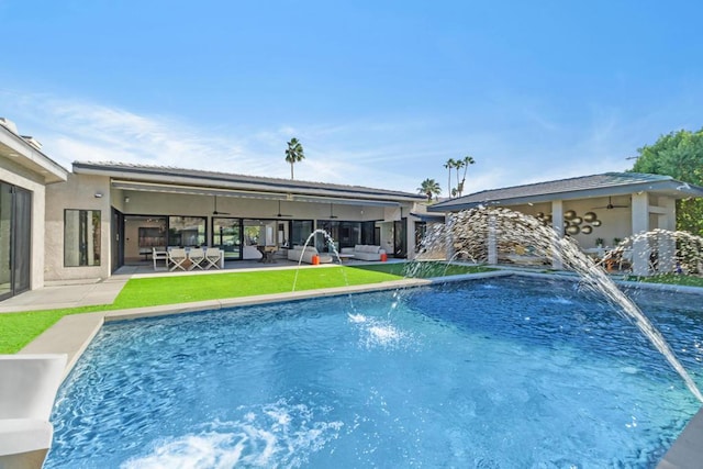 view of pool with pool water feature and a patio