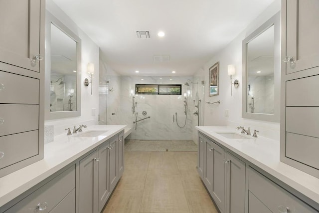 bathroom featuring vanity and a shower with door