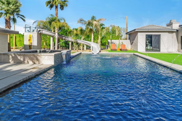 view of swimming pool with a water slide