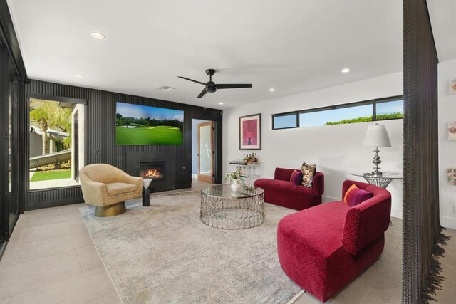 living room featuring ceiling fan and plenty of natural light