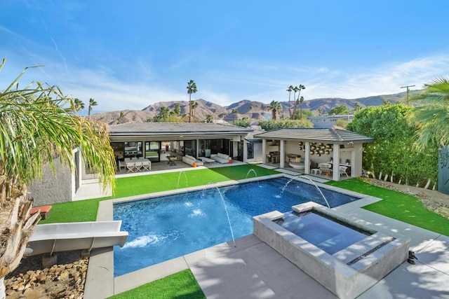 view of swimming pool with an in ground hot tub, a patio area, a mountain view, a yard, and pool water feature