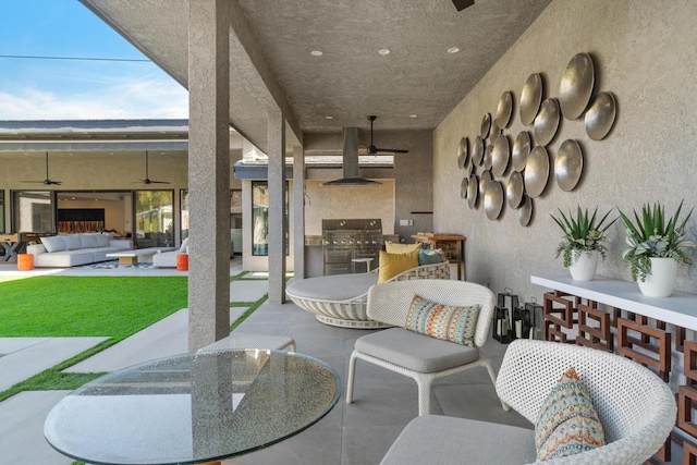 view of patio / terrace featuring ceiling fan, an outdoor living space, an outdoor kitchen, and a grill