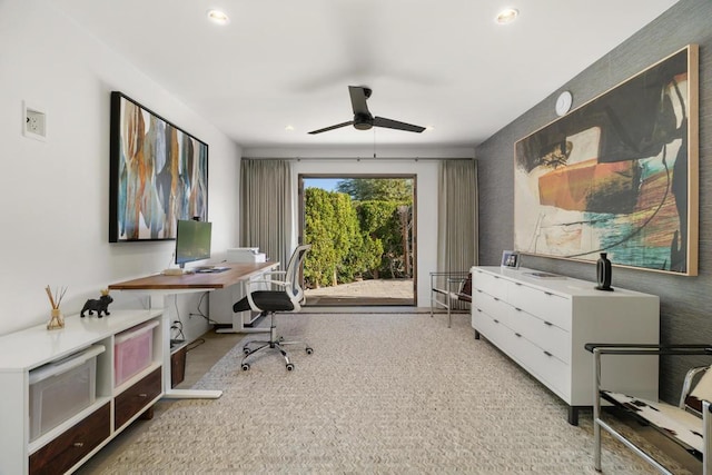 carpeted office space with ceiling fan