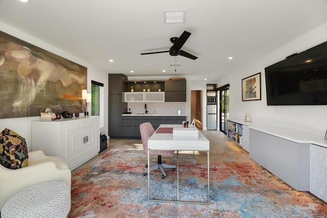 dining space featuring ceiling fan and sink