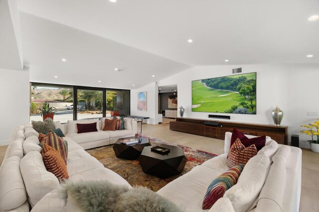 living room featuring expansive windows and vaulted ceiling