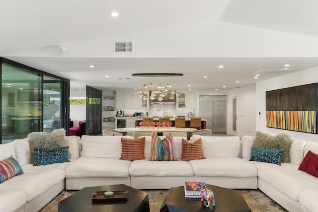 living room featuring lofted ceiling, floor to ceiling windows, and sink