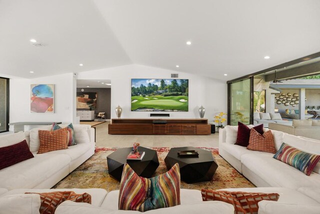 living room with vaulted ceiling and a wall of windows