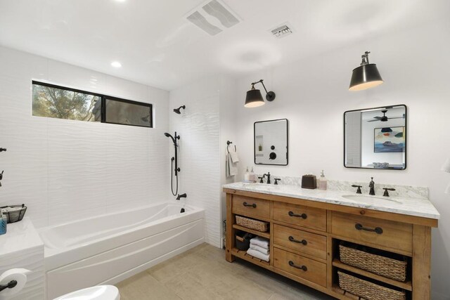 bathroom with vanity and tiled shower / bath