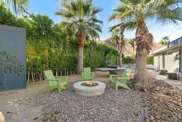 view of yard featuring a mountain view and a fire pit