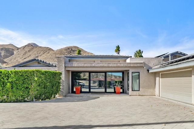 view of front of house with a mountain view and a garage