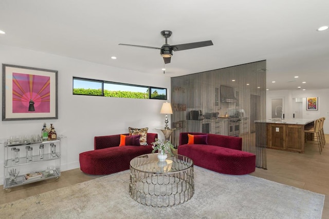 living room with ceiling fan, light hardwood / wood-style flooring, and sink