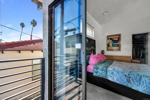 bedroom with vaulted ceiling, a closet, and carpet flooring