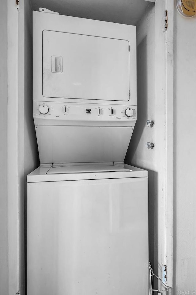 laundry room with stacked washer and dryer