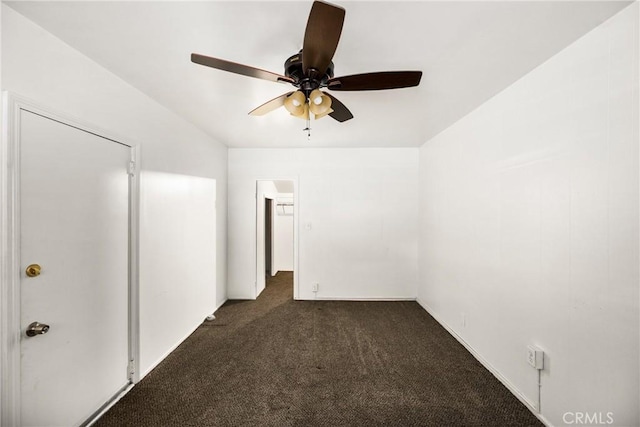 unfurnished room featuring ceiling fan and dark colored carpet