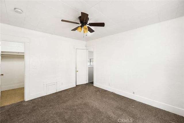 unfurnished bedroom featuring ceiling fan, carpet, and a closet