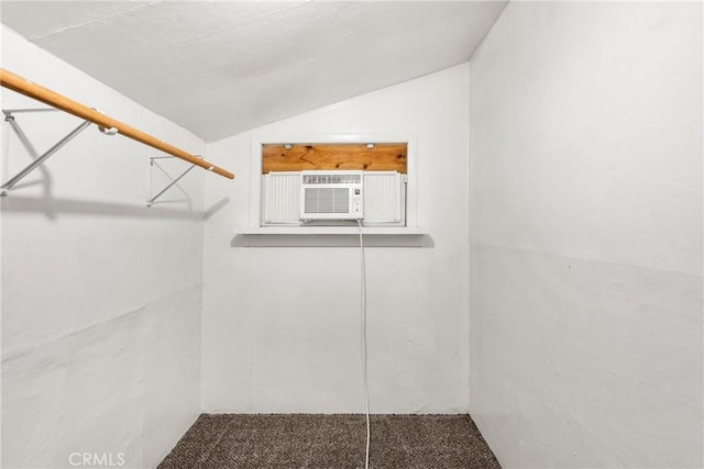 walk in closet featuring carpet floors, cooling unit, and vaulted ceiling