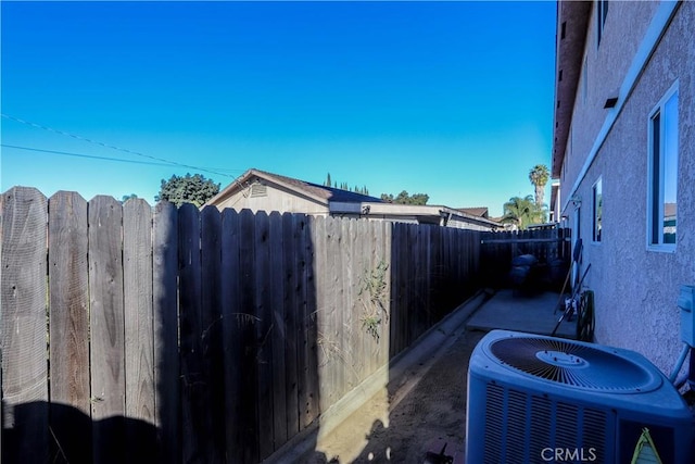 view of side of home with central AC