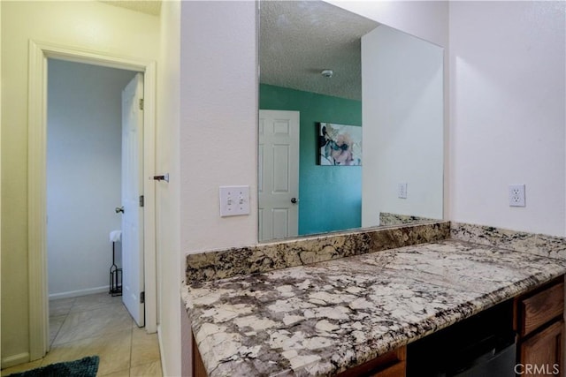 bathroom featuring a textured ceiling, tile patterned floors, and vanity