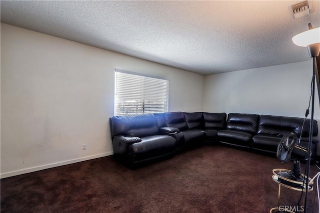 carpeted living room featuring a textured ceiling