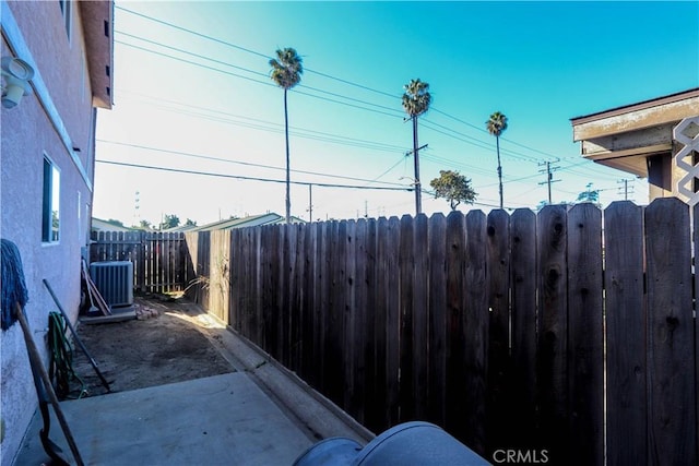 view of yard with cooling unit and a patio area